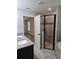 Bathroom showcases a tiled shower, granite counters with dual sinks, and views into an adjacent room at 7677 Sw 81St Pl, Ocala, FL 34476