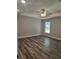Large bedroom with hardwood floors, ceiling fan, neutral walls, and a bright, airy feel at 7677 Sw 81St Pl, Ocala, FL 34476