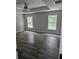 Spacious bedroom with hardwood flooring, tray ceiling with ceiling fan, and bright windows at 7677 Sw 81St Pl, Ocala, FL 34476