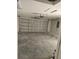 An empty garage featuring a concrete floor, block wall construction, and a functional garage door at 7677 Sw 81St Pl, Ocala, FL 34476