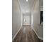 Hallway with wood floors, crown molding, and modern paint leading to the front door at 7677 Sw 81St Pl, Ocala, FL 34476