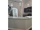 Kitchen island with granite countertop, stainless steel appliances, and sleek dark cabinetry at 7677 Sw 81St Pl, Ocala, FL 34476