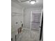 Laundry room with washer hookups, utility sink, overhead wire shelving, and tile floors at 7677 Sw 81St Pl, Ocala, FL 34476