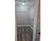 A walk-in closet boasts laminate wood flooring and wire shelving for optimal storage in a compact space at 7677 Sw 81St Pl, Ocala, FL 34476