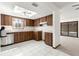 Functional kitchen featuring wood cabinetry, white tile flooring, and ample counter space at 9095 Sw 104Th Ln, Ocala, FL 34481