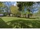 Expansive backyard featuring a well-maintained lawn, mature trees, and secure fencing at 9607 Se 122Nd Pl, Belleview, FL 34420