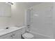 Clean bathroom with white fixtures, tub and shower combination at 9607 Se 122Nd Pl, Belleview, FL 34420