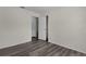Bedroom featuring wood-look floors, neutral walls, and closet at 9607 Se 122Nd Pl, Belleview, FL 34420