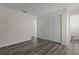 Bedroom featuring wood-look floors, a double closet and neutral colored walls at 9607 Se 122Nd Pl, Belleview, FL 34420