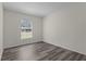 Bedroom with light walls, wood-look floors and a window at 9607 Se 122Nd Pl, Belleview, FL 34420