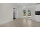 Dining room with tile flooring, white walls, modern light fixture and backyard access through French doors at 9607 Se 122Nd Pl, Belleview, FL 34420