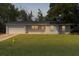 Charming single-story home with a well-manicured lawn and attached garage at twilight at 9607 Se 122Nd Pl, Belleview, FL 34420