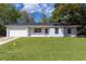 Charming single-story home featuring a well-manicured lawn, attached garage, and newly painted exterior at 9607 Se 122Nd Pl, Belleview, FL 34420