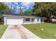 Charming single-story home featuring an attached garage, driveway, and well-manicured front lawn at 9607 Se 122Nd Pl, Belleview, FL 34420