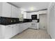 Cozy kitchen area featuring white cabinets, wood look flooring, and neutral walls at 9607 Se 122Nd Pl, Belleview, FL 34420