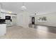 Bright and airy living room featuring hardwood floors, a dark wood front door, and modern lighting at 9607 Se 122Nd Pl, Belleview, FL 34420