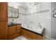Bright bathroom features a freestanding tub with elegant fixtures, a crystal chandelier, and plenty of cabinet space at 9770 Sw 97Th Pl, Ocala, FL 34481