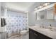 Well-lit bathroom boasts a shower-tub combo, classic vanity, a large mirror, and neutral tones at 9770 Sw 97Th Pl, Ocala, FL 34481
