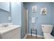 Cozy, blue bathroom features a standing shower and a sink with cabinet at 9770 Sw 97Th Pl, Ocala, FL 34481