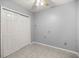 This bedroom features tile flooring, closet, light gray walls, and a ceiling fan at 9770 Sw 97Th Pl, Ocala, FL 34481