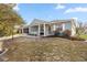 Charming single-story home boasts a screened porch, manicured lawn and vibrant red flower bushes at 9770 Sw 97Th Pl, Ocala, FL 34481