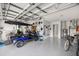 Spacious garage with epoxy flooring, a golf cart, tools, and great storage opportunities at 9770 Sw 97Th Pl, Ocala, FL 34481