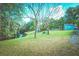 The expansive backyard with lush green grass and pond offers a serene escape for relaxation and recreation at 9795 Ne 303Rd Ave, Salt Springs, FL 32134