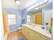 Bright bathroom offers dual windows, a large vanity, and ample counter space at 9795 Ne 303Rd Ave, Salt Springs, FL 32134