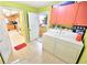 Functional laundry room featuring washer, dryer, cabinets, and a tile floor offers convenience and storage at 9795 Ne 303Rd Ave, Salt Springs, FL 32134