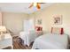 Twin beds and neutral decor create a calming guest bedroom at 1004 Parker Pl, Lady Lake, FL 32159