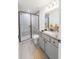 Modern bathroom with a glass-enclosed shower and elegant vanity with granite countertop at 10069 Sw 140Th Ave, Dunnellon, FL 34432