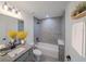 Well-lit bathroom with a combined shower and tub and a sleek vanity with granite countertop at 10069 Sw 140Th Ave, Dunnellon, FL 34432