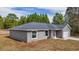 New construction home featuring a modern exterior, landscaped yard, attached garage, and architectural roof shingles at 10069 Sw 140Th Ave, Dunnellon, FL 34432