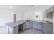 Bright kitchen with an island with a granite countertop and storage at 10069 Sw 140Th Ave, Dunnellon, FL 34432