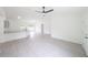 Open concept living area with lots of space, gray floors, a breakfast bar and bright neutral paint at 10069 Sw 140Th Ave, Dunnellon, FL 34432