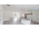Open-concept living space with kitchen island, modern finishes, and ample natural light at 10069 Sw 140Th Ave, Dunnellon, FL 34432