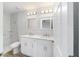 Modern bathroom with double vanity, marble-style tile shower, and updated fixtures at 13395 Sw 106 St, Dunnellon, FL 34432
