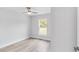 Bright bedroom with a large window, laminate flooring, ceiling fan and fresh paint at 13395 Sw 106 St, Dunnellon, FL 34432