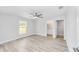 Spacious bedroom with ceiling fan, a large window, and luxury vinyl floors at 13395 Sw 106 St, Dunnellon, FL 34432