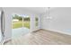 Dining area with sliding glass doors, hardwood floors, and modern chandelier at 13395 Sw 106 St, Dunnellon, FL 34432