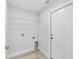 Clean laundry room with overhead shelving, modern hookups, and an exterior door at 13395 Sw 106 St, Dunnellon, FL 34432
