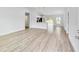 Bright living room featuring new vinyl floors and a kitchen with a breakfast bar at 13395 Sw 106 St, Dunnellon, FL 34432