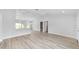 Bright living room featuring new vinyl floors and a kitchen with a breakfast bar at 13395 Sw 106 St, Dunnellon, FL 34432
