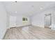 Open-concept living room showcasing vinyl flooring, recessed lighting, and a modern kitchen at 13395 Sw 106 St, Dunnellon, FL 34432
