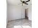 Airy bedroom with a ceiling fan and a large window, showcasing laminate flooring at 13627 Sw 103Rd Pl, Dunnellon, FL 34432