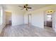 Spacious bedroom featuring a ceiling fan, wood-look floors, and ample natural light at 13627 Sw 103Rd Pl, Dunnellon, FL 34432