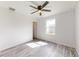 Light and airy bedroom with a ceiling fan, laminate flooring, and a double door closet at 13627 Sw 103Rd Pl, Dunnellon, FL 34432
