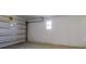 Interior view of garage with window, and garage door at 13627 Sw 103Rd Pl, Dunnellon, FL 34432