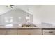 Kitchen island with stainless steel sink, granite countertop, and gray cabinets at 13627 Sw 103Rd Pl, Dunnellon, FL 34432