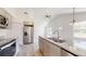 Kitchen with stainless steel appliances, gray cabinets and view to living area at 13627 Sw 103Rd Pl, Dunnellon, FL 34432